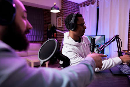 Creative people recording social media podcast with sound equipment, using vlog station to live...