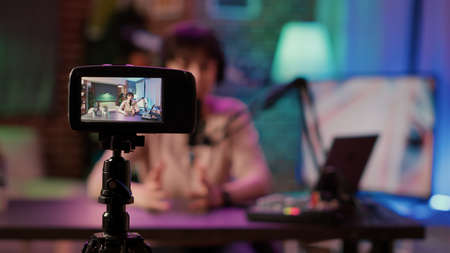 Selective focus on digital video camera screen recording content creator streaming live internet...