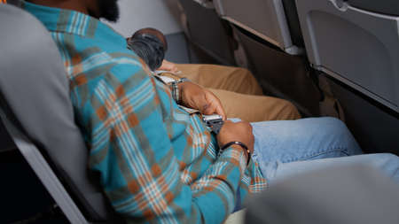 Male passenger bucking safety seatbelt with strap and lock for security and precaution. Fastening...