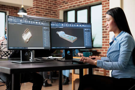 Digital creator improving prototype mesh using advanced computer and software while sketching 3D scene. Skilled creative professional creating digital model while solving technical issues.の写真素材
