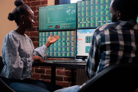 Forex stock market company professional traders analyzing real time financial data to predict market...