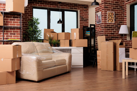 Empty living room apartment with boxes to move in and relocate household in rented flat. Moving in...