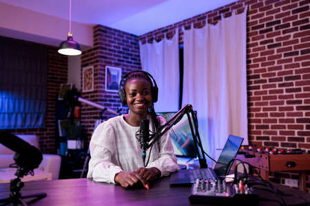 POV of african american influencer recording talk show, looking at camera to film social media...