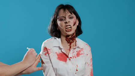 Frightening weird looking zombie angered by vaccine immunity injection. Creepy evil brain-eating...