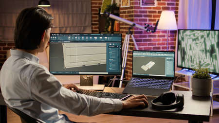 Industry technician manufacturing product component on computer, using engineering software to...