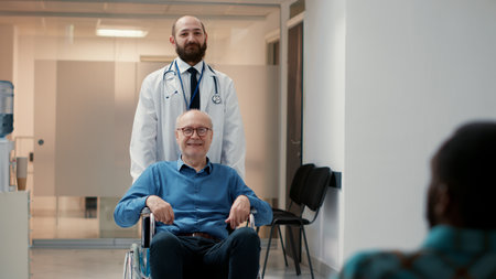 Portrait of retired patient with physical disability and impairment, male doctor helping with...