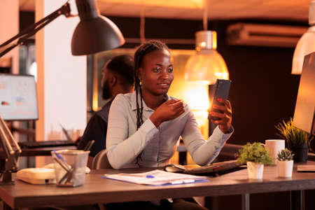 Young startup employee using remote videocall conference to talk to business people about corporate paperwork. Chatting on online teleconference call meeting, video telework on webcam.の写真素材