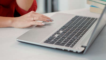 Office worker using laptop to plan financial development, doing sales research with company statistics. Female employee planning business growth with analysis on computer. Close up.の写真素材