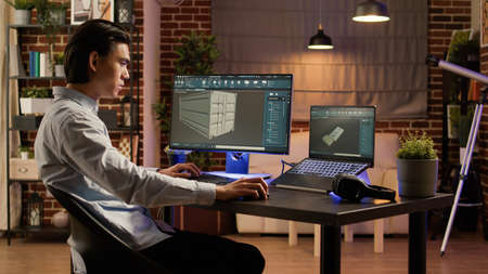 Asian engineer manufacturing industrial product on pc software, using computer screen to develop...