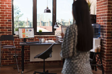 Agency office worker having management chart in hand. Young asian marketing company businesswoman...