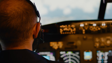 Male aviator using handle and windscreen in cockpit to fly airplane, throttling power engine to takeoff. Commanding aircrew and using control panel dashboard. Close up.の写真素材