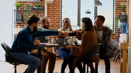 Diverse team of coworkers having successful partnership and feeling happy about professional...
