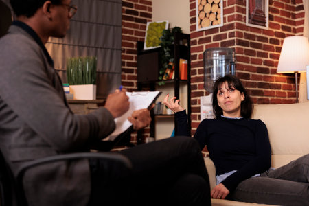 Stressed person with psychological issues attending therapy session to talk to specialist, laying on...