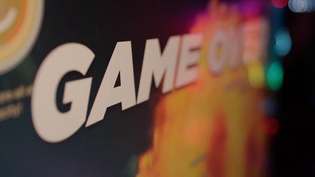 Extreme closeup on game over text on computer screen after failing level in online space shooter on gaming pc setup. Losing message and statistics on monitor at the end of multiplayer session.の写真素材