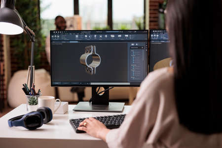 Industry worker developing machinery gears product, engineering industrial turbine production on computer at home. Freelancer working on construction manufactory with creative software.の写真素材