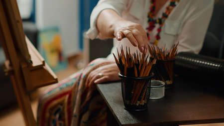 Colorful drawing pencils and artistic equipment on table to create professional artwork sketch on...