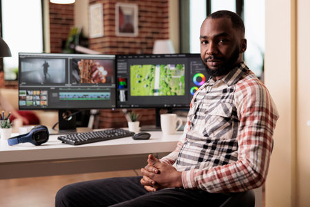 Portrait of graphic editorworking on video editing software to make film montage, creating movie footage for post production industry. Filming creator using multimedia panel to edit content.の写真素材