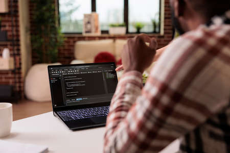 Diverse freelance coders programming html script at home, using encryption and program code to...