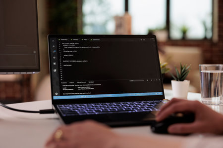 Freelance software app developer using terminal windows at home, programming security firewall, running css html script. Programmer developing new user interface online cloud server. Close up.の写真素材