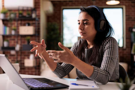 Office worker using videocall meeting online on laptop to talk to colleagues, chatting on...