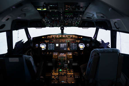 Empty airplane cabin with radar compass windscreen and navigation, control panel command used by captain or pilot to fly aircraft jet. Aerial transportation with engine throttle and dashboard.の写真素材