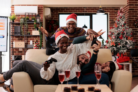 Diverse coworkers enjoying video games play on xmas day at office party event, celebrating christmas...
