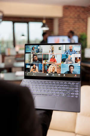 Female freelancer talking on online videocall conference with business people, using remote...