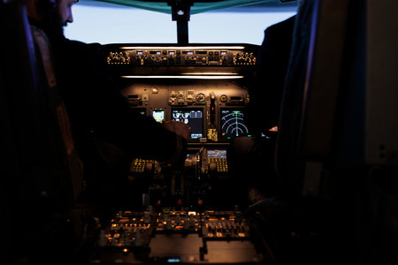 Multiethnic team of captain and pilot switching engine throttle lever to takeoff with airplane from aviation cockpit. Aircrew men flying plane jet using dashboard and control panel command.の写真素材