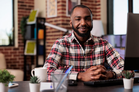Portrait of business man doing remote job, sitting at home desk with research information on...