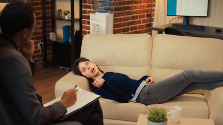 Unhappy woman talking to therapist about marriage problems, complaining about conflict laying on...