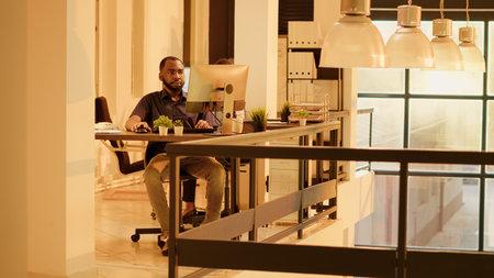 African american colleagues leaving office job together during sunset hour after finishing...