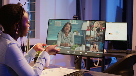 Business woman meeting with colleagues on online videocall, talking to people on remote...