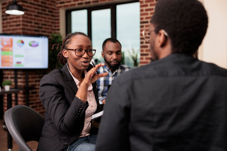 Startup colleagues planning business presentation with data research, brainstorming ideas to create report. Doing teamwork collaboration with documents in corporate meeting, partnership.の写真素材