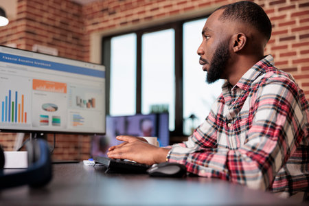 Business manager checking diagrams on computer, analyzing research data information on chars to create startup report and send email. Working remotely from home, doing freelance presentation.の写真素材