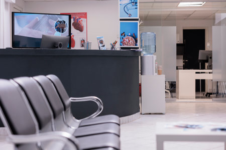 Empty hospital waiting area in lobby with reception desk at health center, used to help patients with checkup appointments on healthcare insurance support. Medical waiting room.の写真素材
