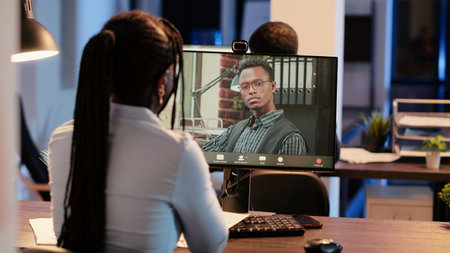 Business woman attending videocall online meeting with man, talking on remote videoconference call...