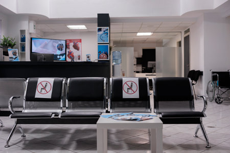 General shot of empty hospital waiting area. Sectioned seats to prevent covid 19 infection at no...