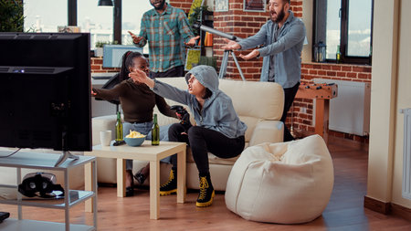 Diverse people feeling sad about losing online competition, playing video games on tv console at home party. Friends being frustrated about lost game play on television, lose challenge.の写真素材