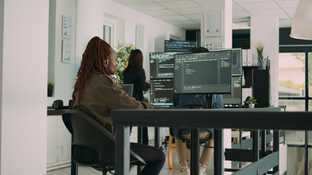 African american programer typing source code on computer to create new user interface. Software...