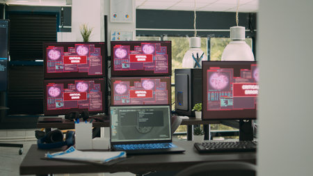 Computer screens running hacking alert security breach in empty software it agency office, critical...