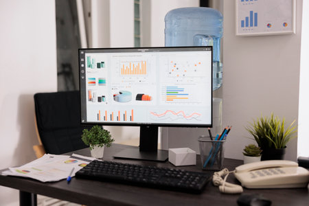 Close up view of monitor with sales growth graphs on screen prior to brainstorming meeting....