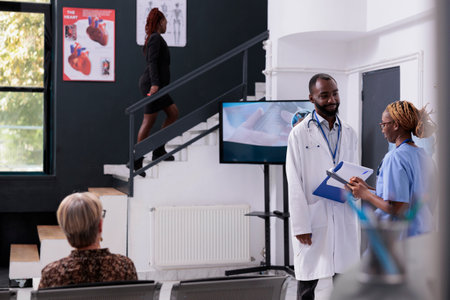 Physician medic discussing medication treatment with nurse during checkup visit appointment in...