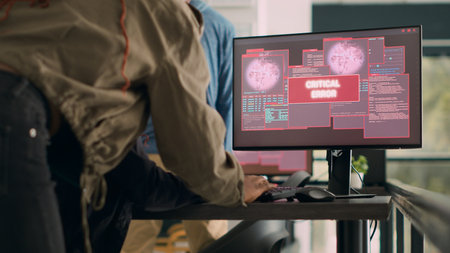 Team of software developers dealing with security breach and hacked it system on multiple computers....