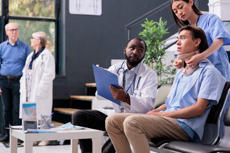 Nurse and elderly traumatologist helping injured asian patient with cervical neck collar, giving support to remove foam brace and recover after trauma. Checkup visit consultation in hospital receptionの写真素材