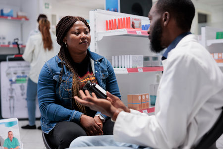 African american client buying pills bottle in pharmacy store, pharmacist advising vitamins....