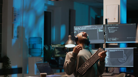 Careless html coder playing air guitar with keyboard, having fun and acting silly after hours. IT...