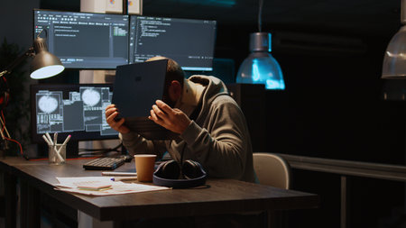 Database admin with neck collar foam working on code developing at night, typing html script on...