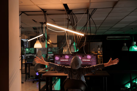 Hacker celebrating successful computer system password hacking. Cyberattack, scammer sending virus, breaking into database online server, stealing privacy data information, back viewの写真素材