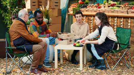 Diverse group of people tasting slices of apples at food fair, having fun together with vendors....