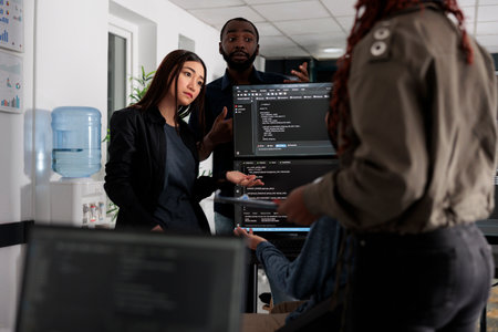 Software engineers collaborating on coding project talking about programming algorithm for new cloud computing user interface. Diverse team of web developer running database system code.の写真素材